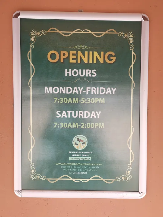 The opening-hours sign displayed at a Buwambo Microfinance office