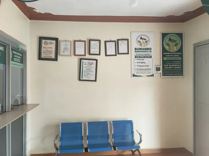 The office waiting area with chairs and framed certificates